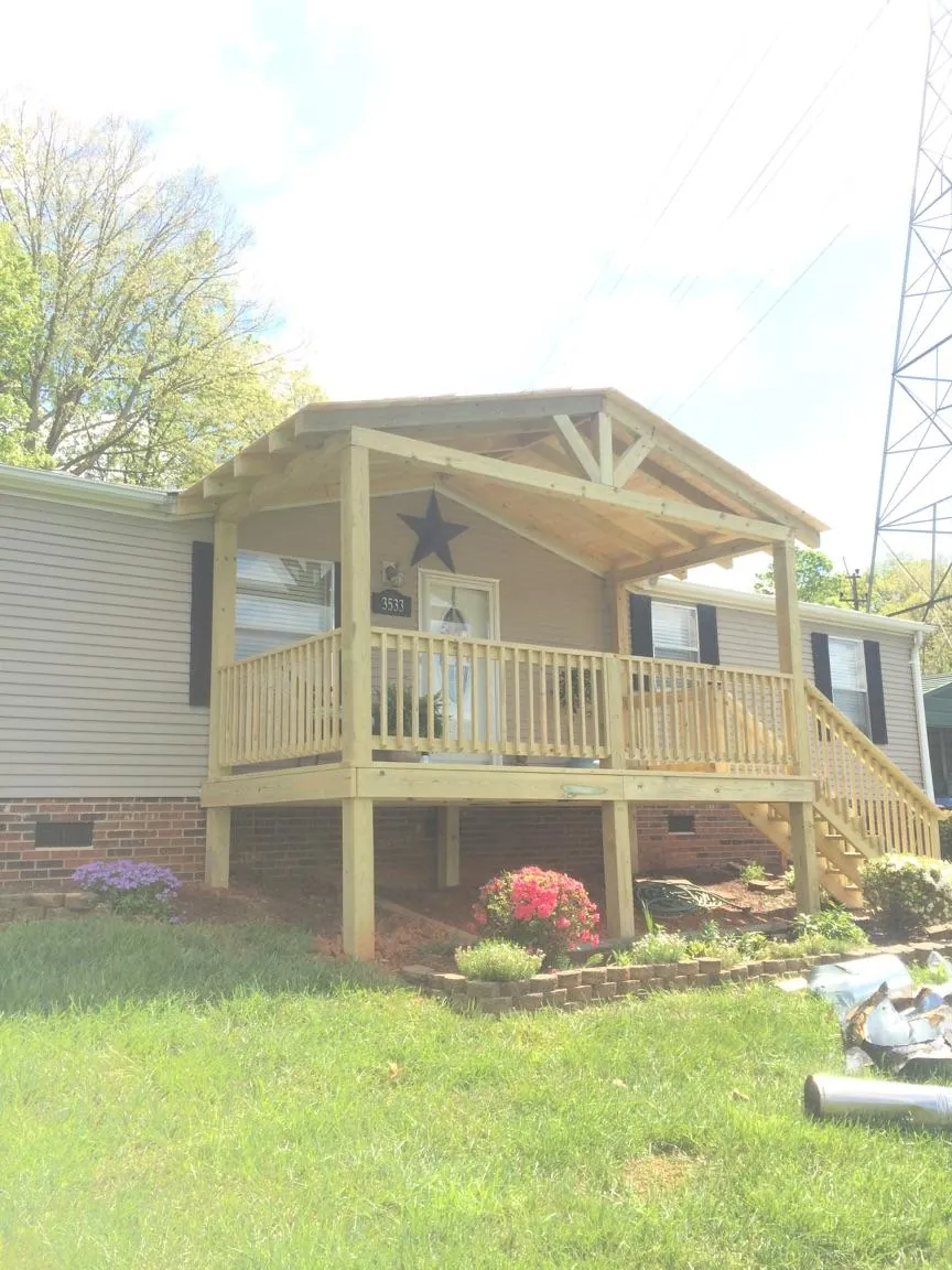 New gabled porch roof and deck railing added to a ranch home in Northfield